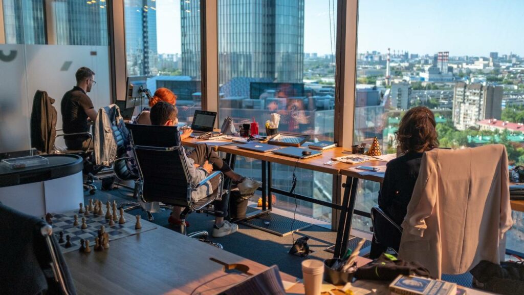 Four employees in an office with a great view of the city 