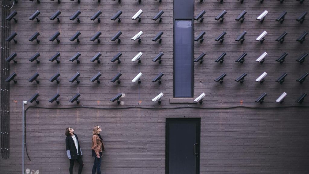 two people surveilled by dozens of CCTV cameras