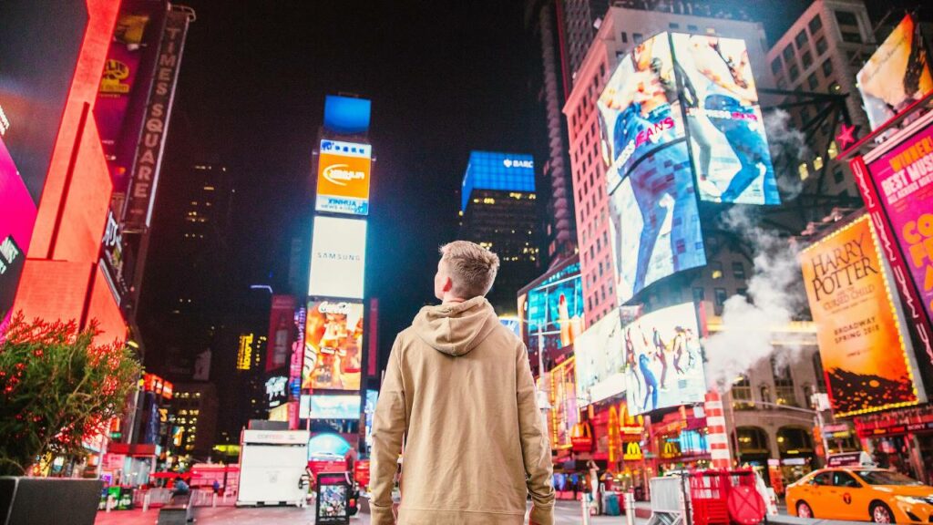 A boy standing in New York's Times Square
