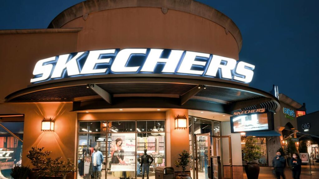 A big Sketchers neon logo on a round building